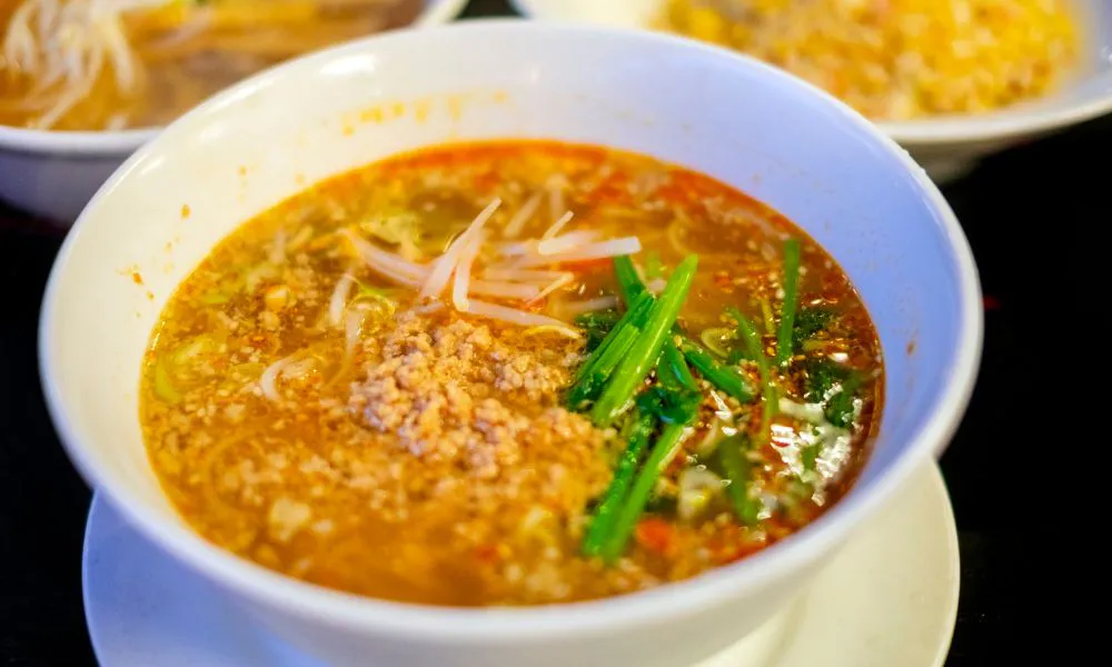 Spicy pork noodle soup with bean sprouts and herbs at Lucky Dumplings, a Dumpling Restaurant in Great Neck